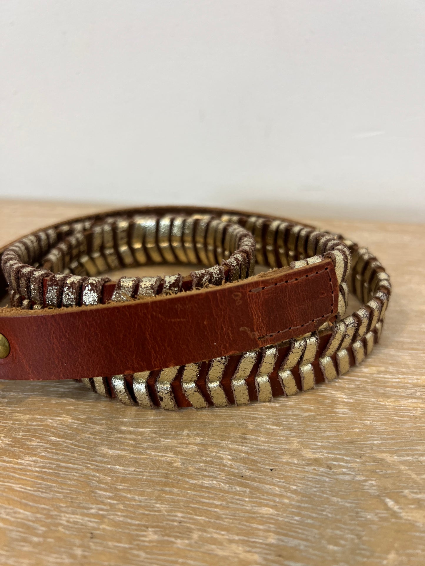 THAT ONE OR THAT ONE. Reddish leather belt. TM