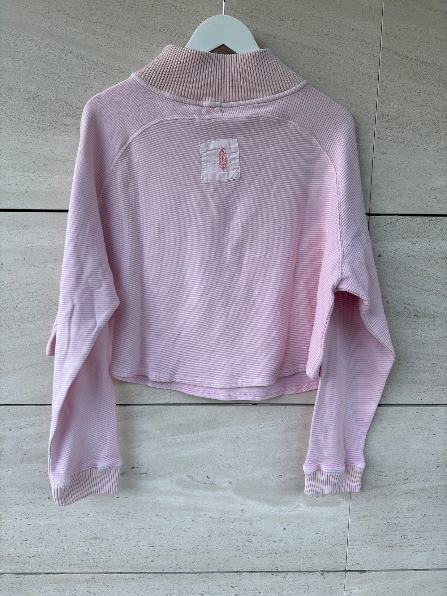 FREE PEOPLE MOVEMENT. Sudadera rosa claro textura