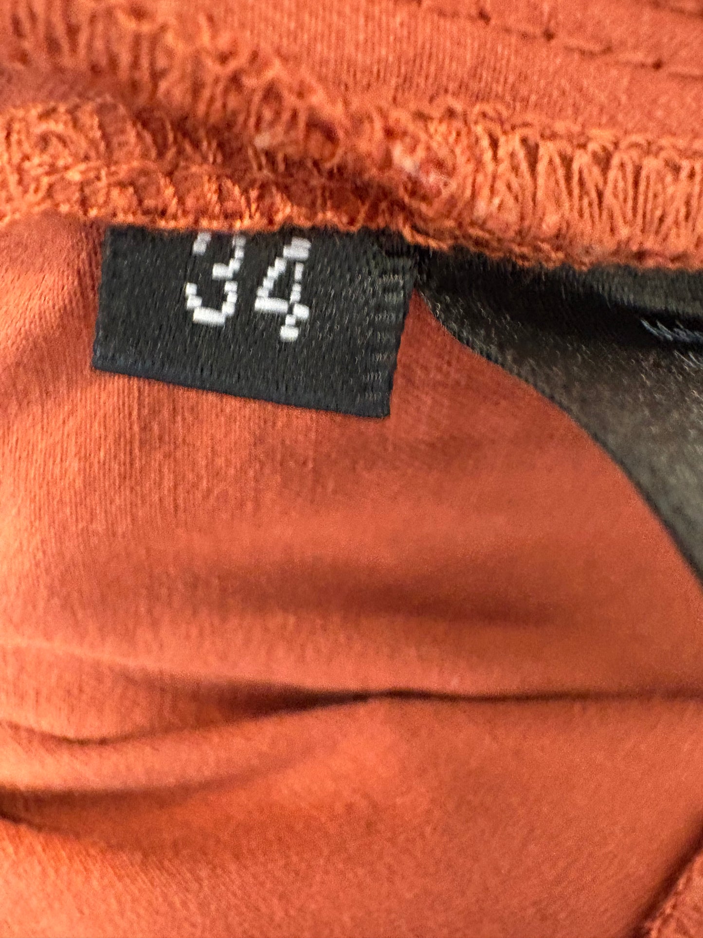 STELLA NOVA. Pantalón rojizo detalle bajo