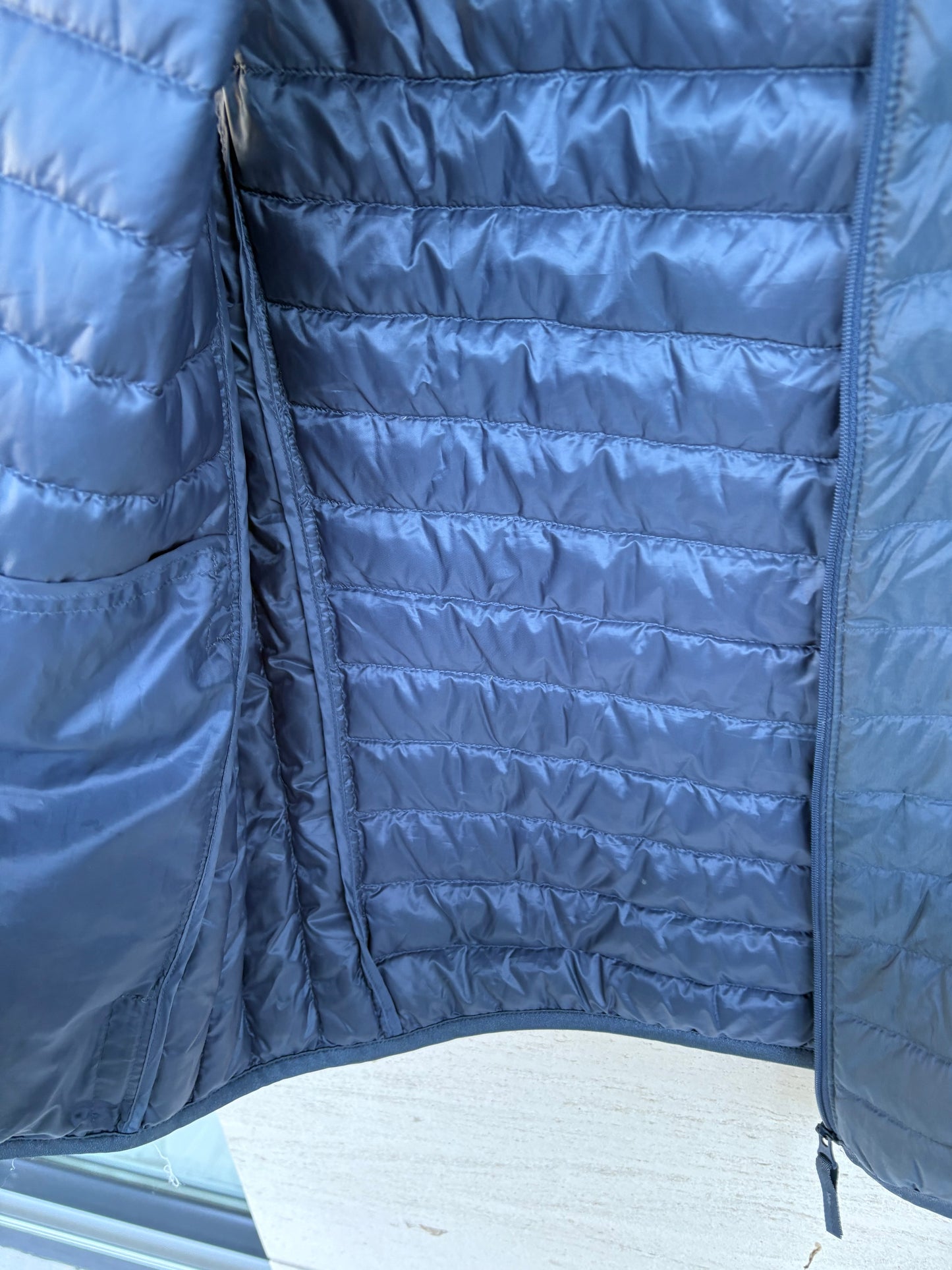 UNIQLO. Ultralight down vest in blue. XS