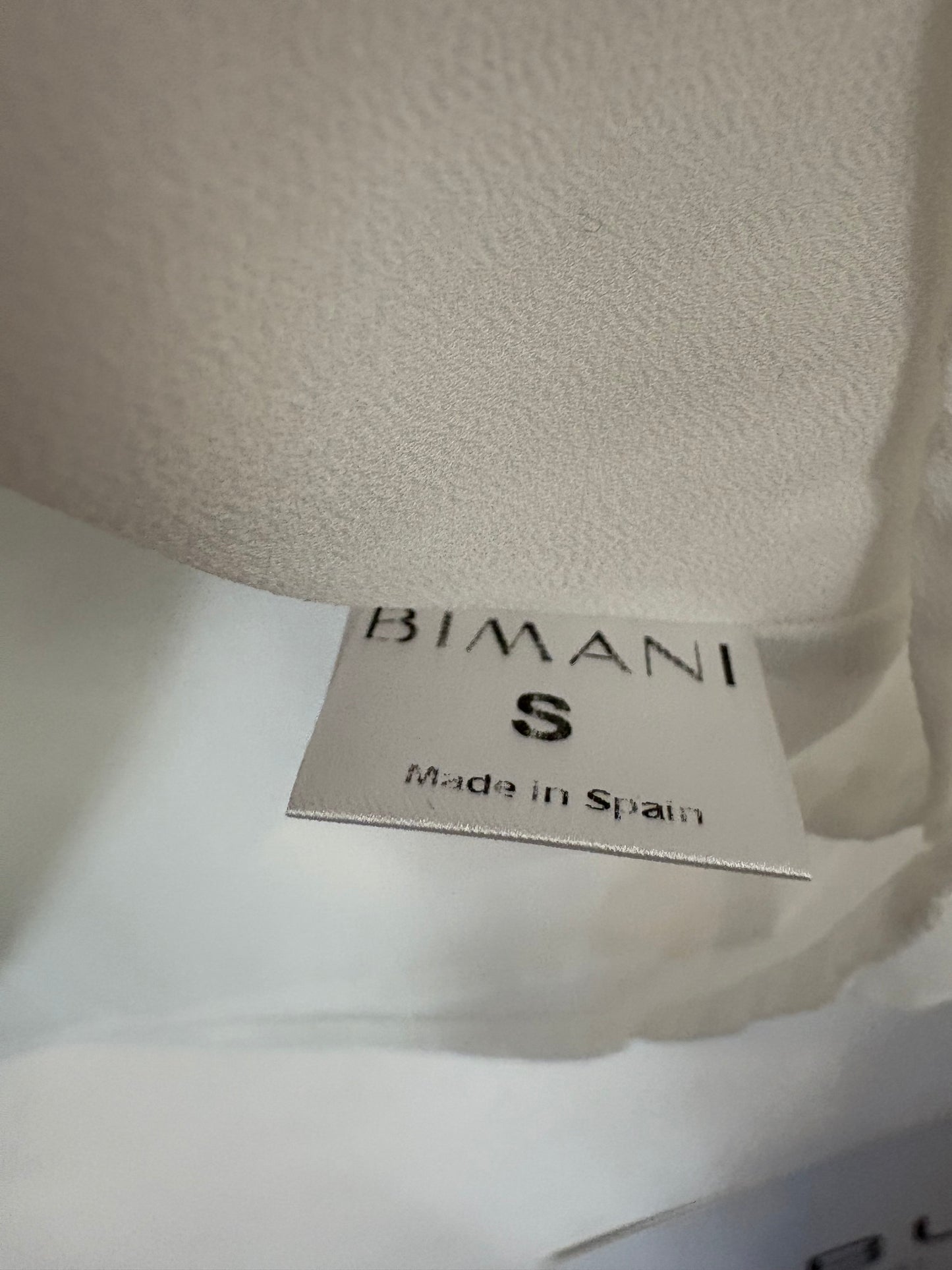 BIMANI. Blusa blanca escote fluido
