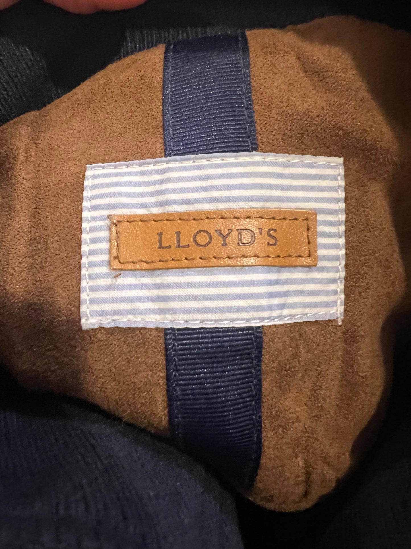 LLOYD'S. Blue down jacket with suede detailing.
