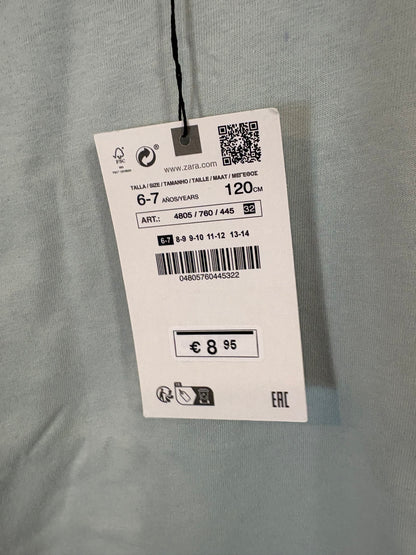 ZARA. Camiseta tono azul claro dibujos. T 6-7 años