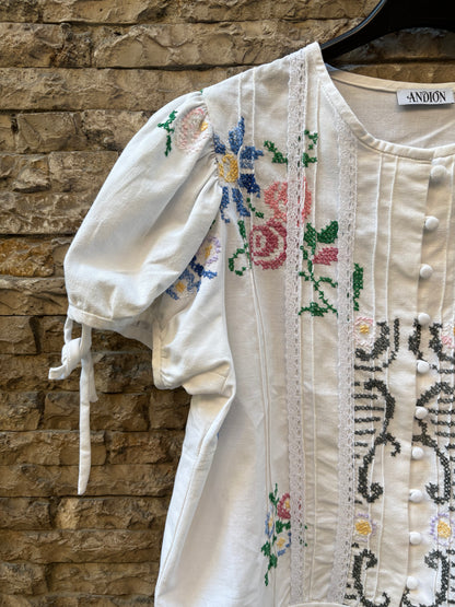 ANDION. Blusa blanca bordada a mano