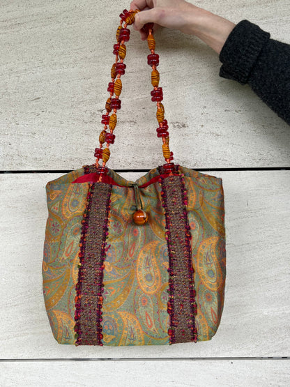 HELENE MENASCHE. Bolso estampado detalle asa