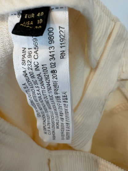 ZARA. Vestido midi plisado en crudo