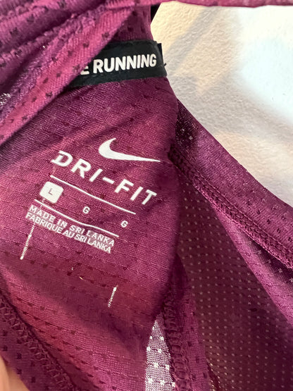 NIKE. Top burdeos running. T L
