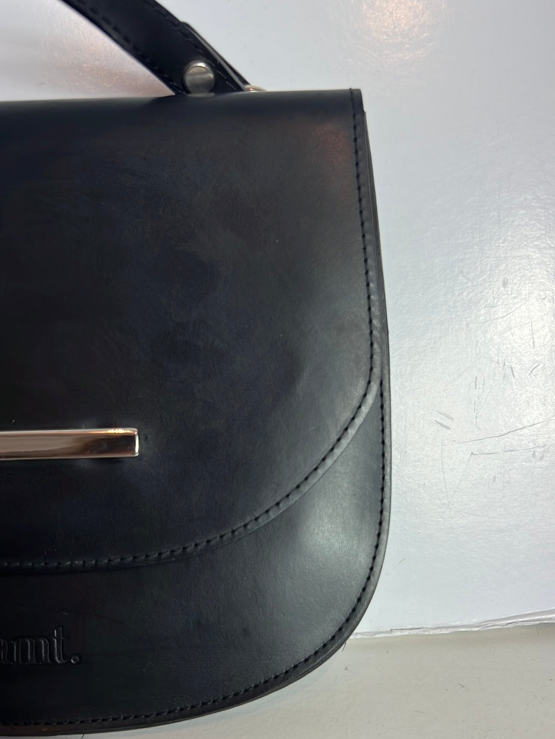 AMT. Flat black mini bag