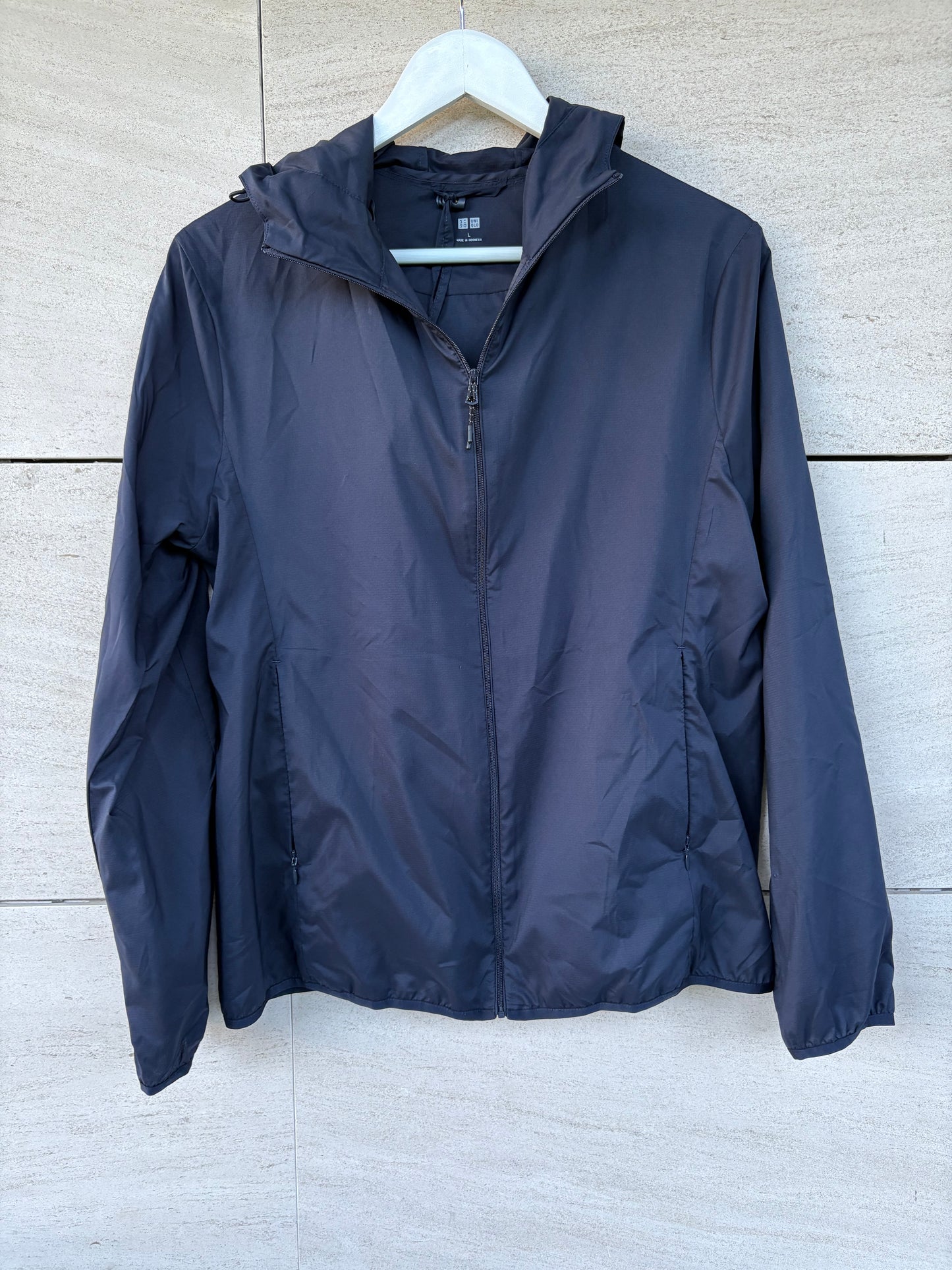 UNIQLO. Navy blue pocketable windbreaker. TL