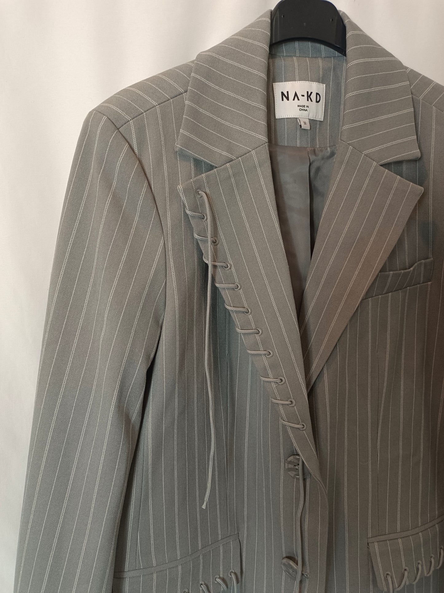 KA-KD. Gray blazer with Ts stripes