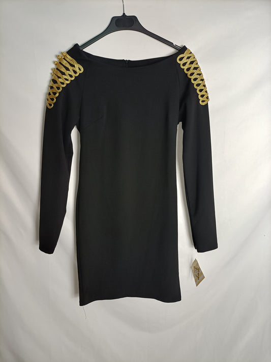 XICA BOUTIQUE. Black dress with gold detailing on the shoulders.