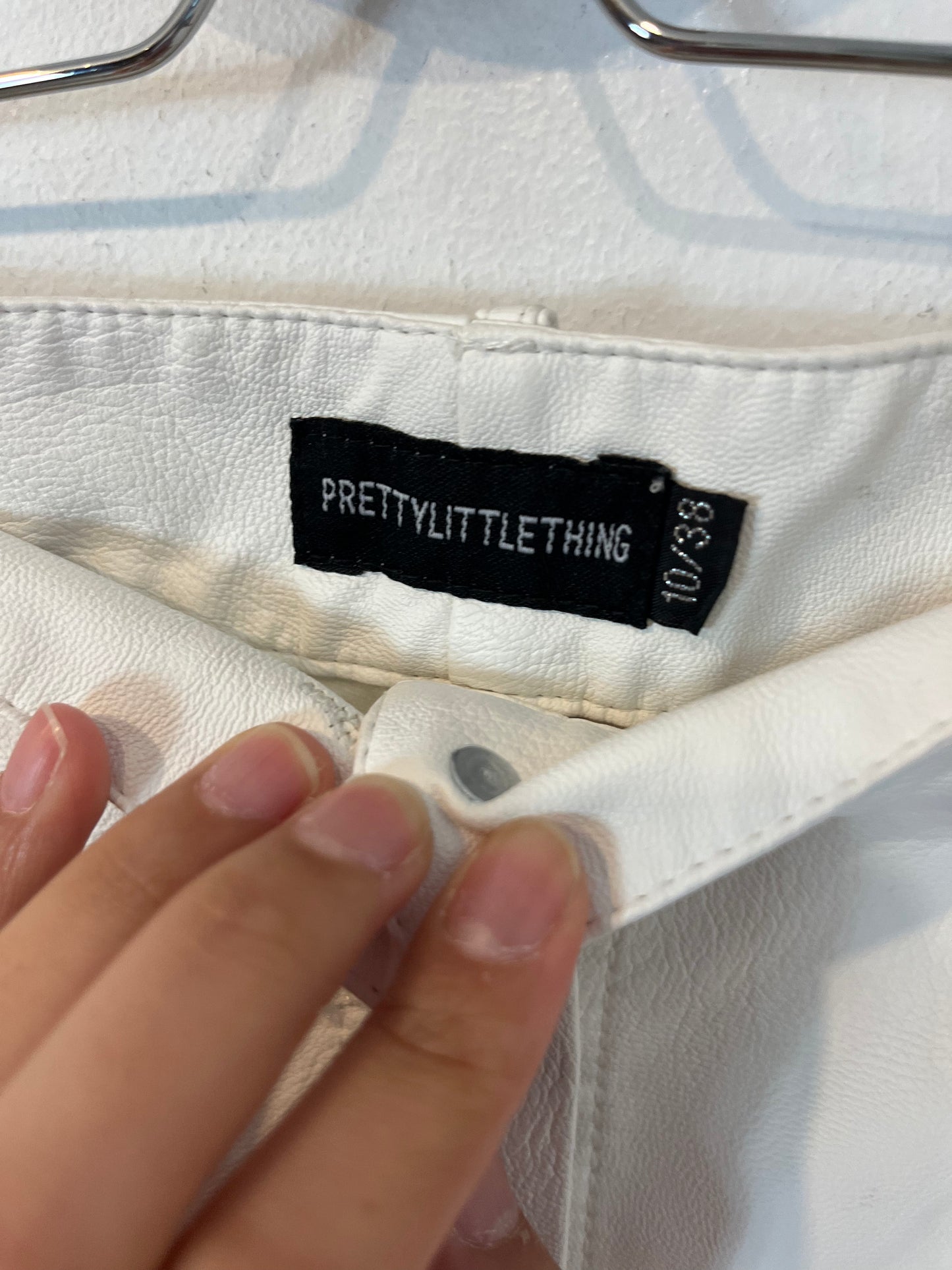 PRETTYLITTLETHING. White buttoned faux leather skirt. Size 38