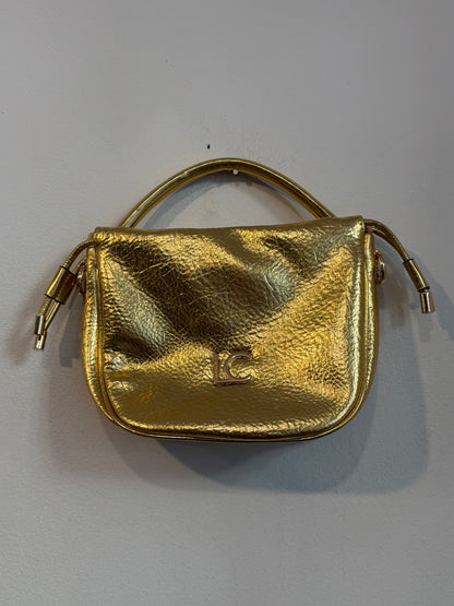 LOLA CASADEMUNT.  Bolso de mano dorado efecto piel