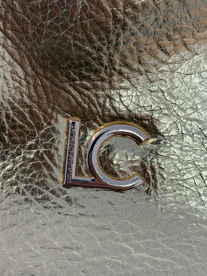 LOLA CASADEMUNT.  Bolso de mano dorado efecto piel