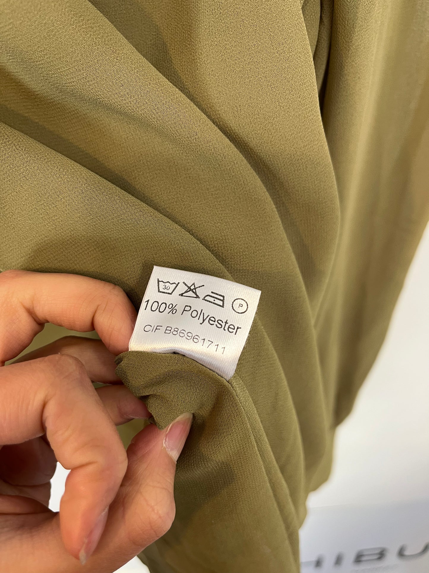 BIMANI. Flowing green blouse with a bow at the neck and gold buttons. Size XL