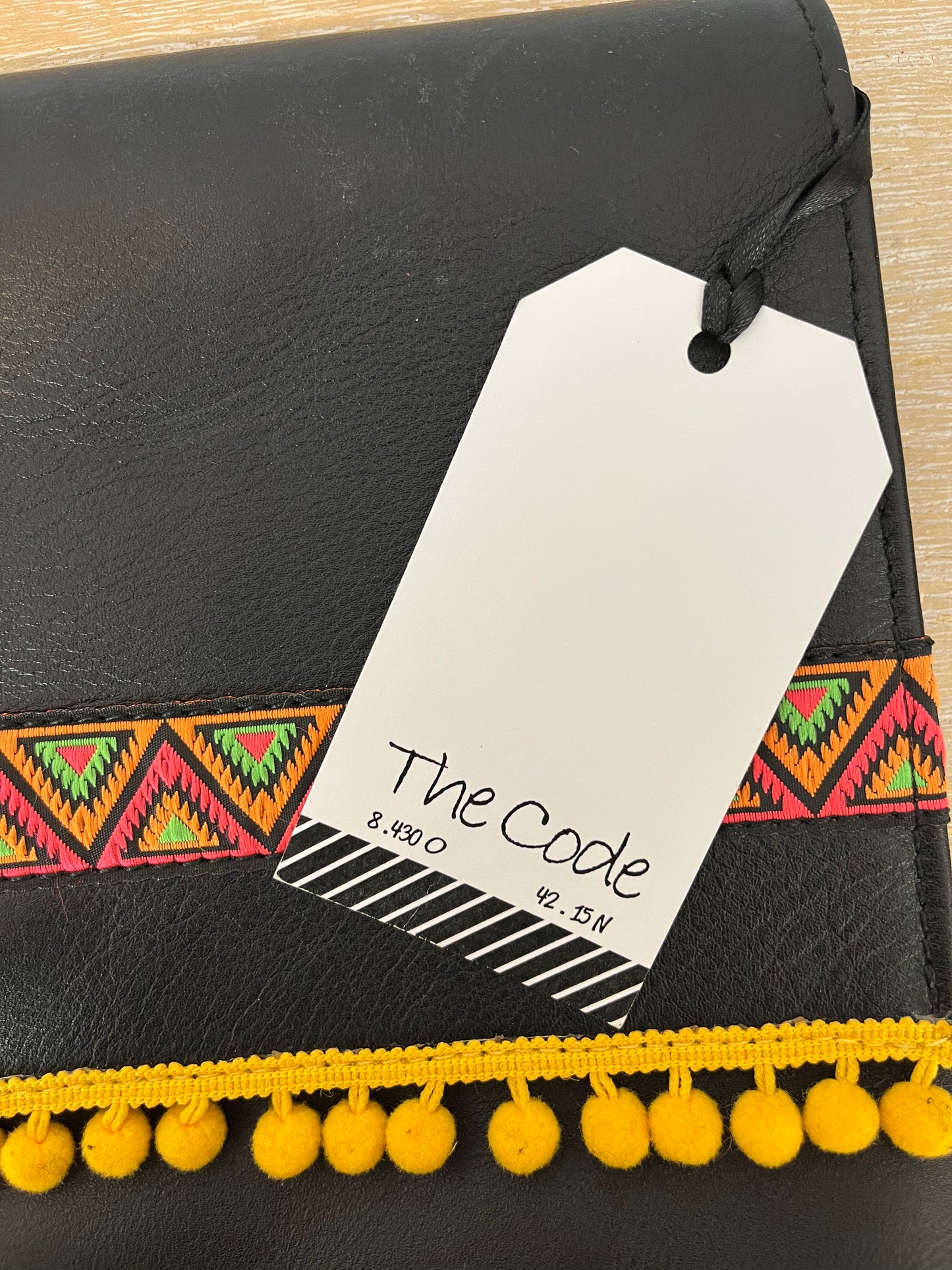 THE CODE. Black tassel clutch