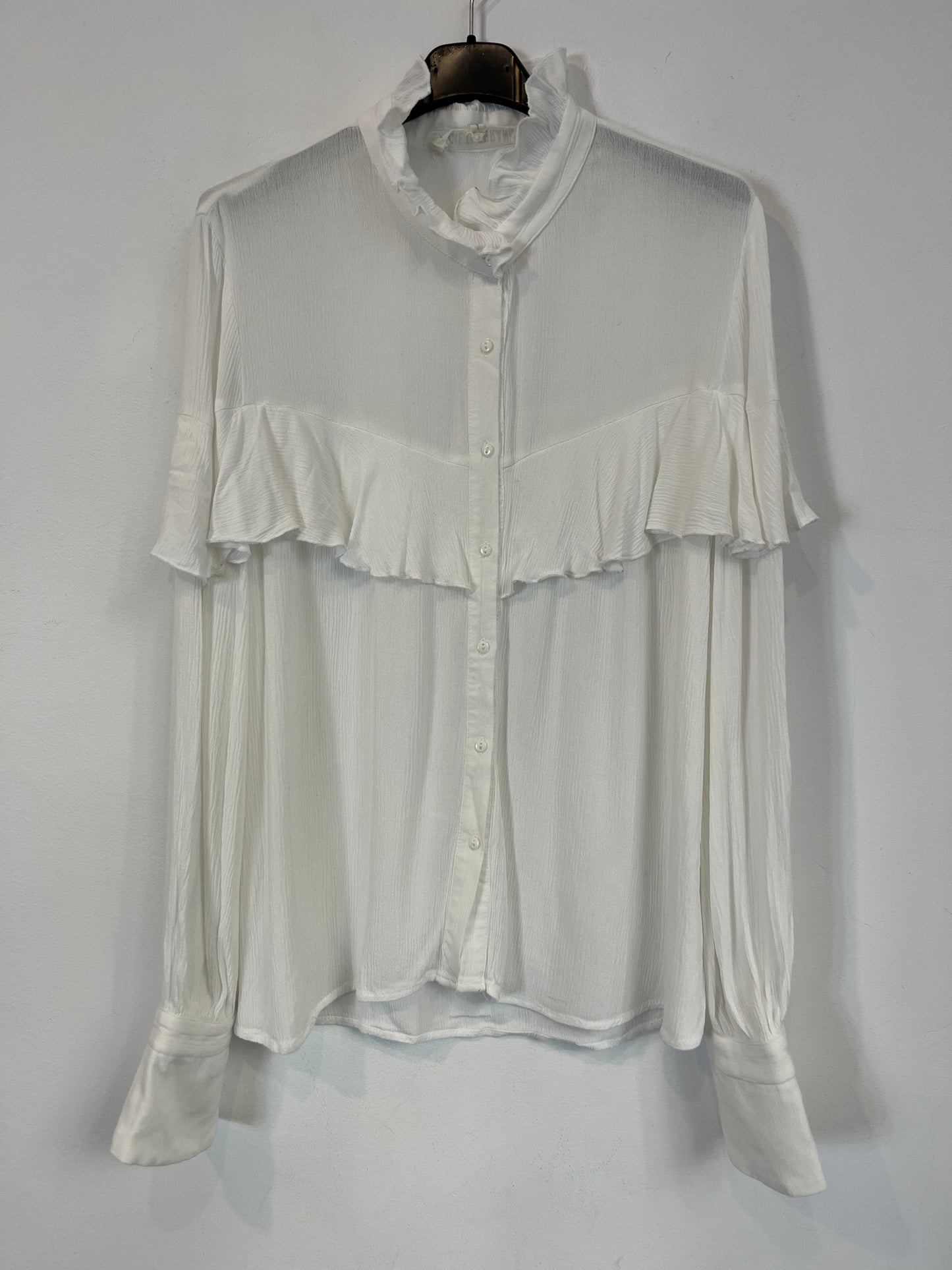 NAME THE BRAND. White ruffled blouse. TL
