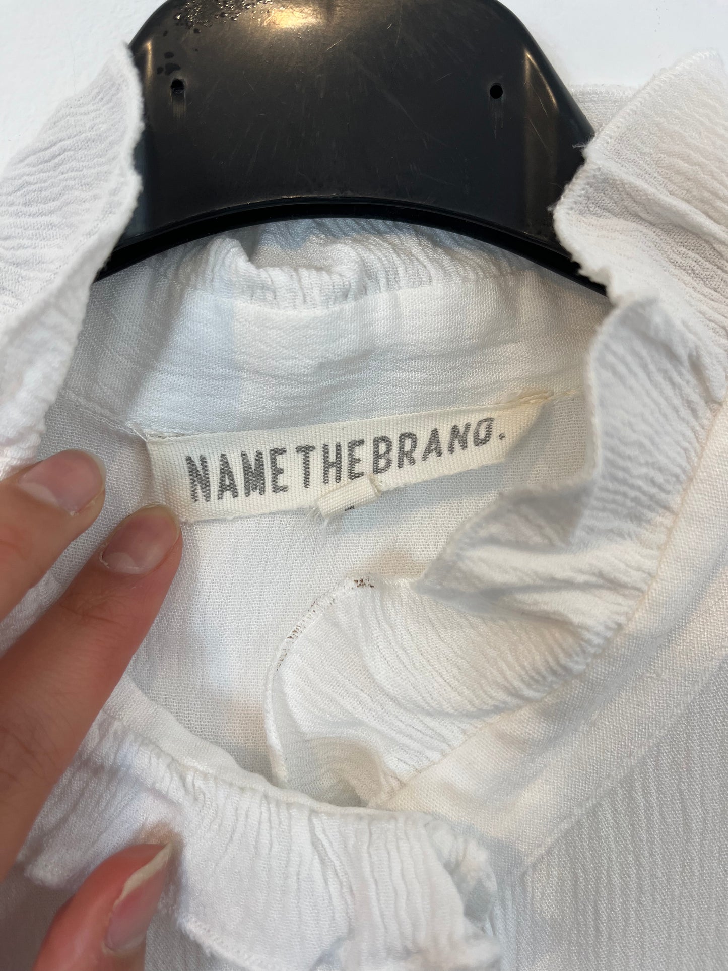 NAME THE BRAND. White ruffled blouse. TL