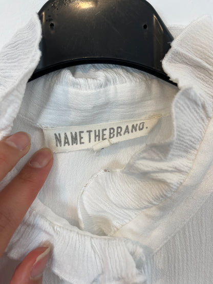 NAME THE BRAND. White ruffled blouse. TL