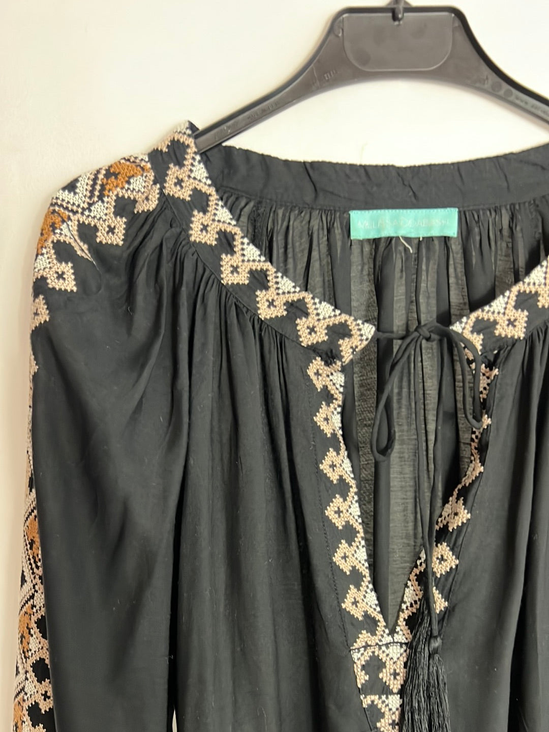 MELISSA ODABASH. Black blouse with cross-stitch details. YOU