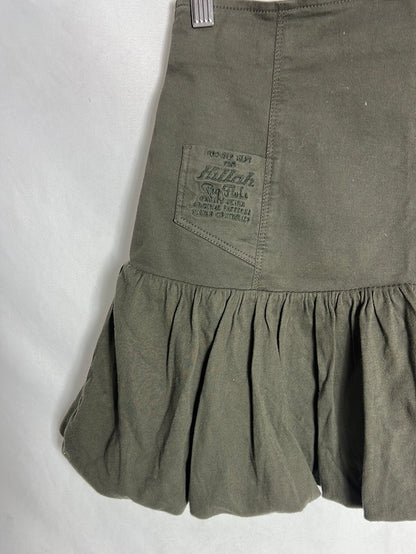 KILLAH. Short green ruffled skirt. TL
