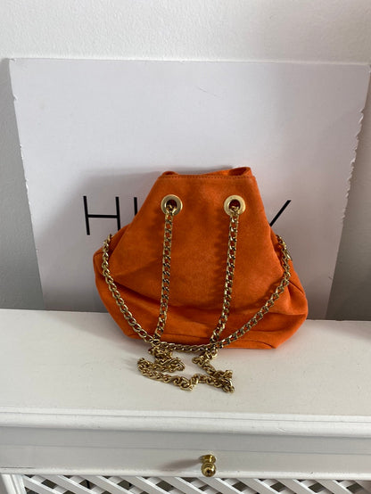 CUPLÉ. Bolso piel naranjas