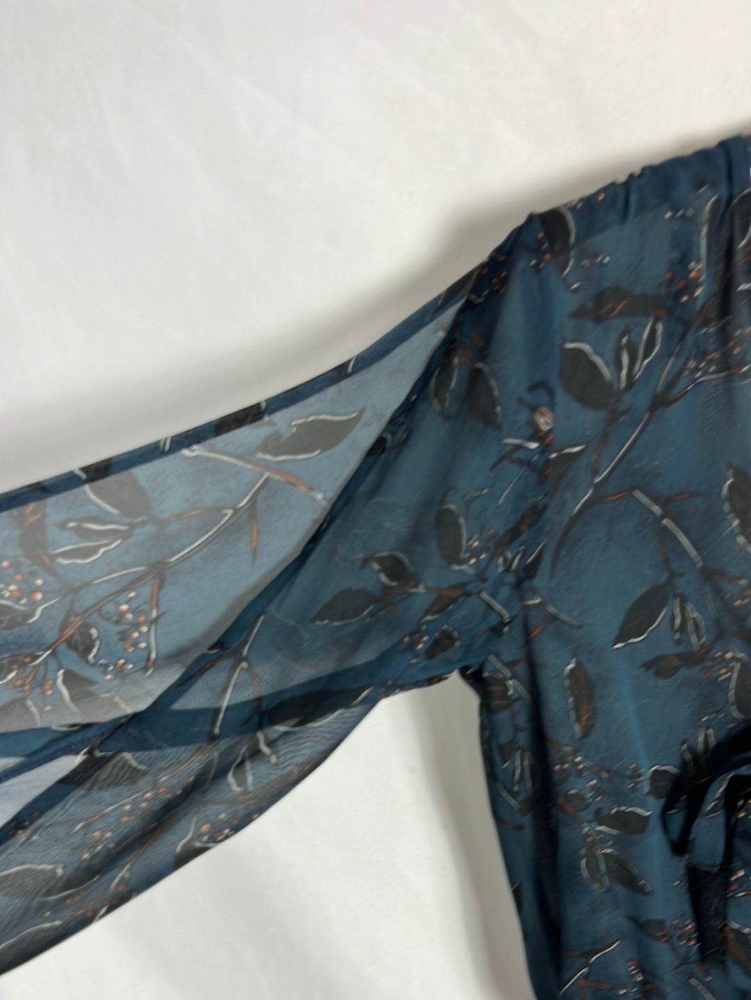 OTHERS. Blue printed bodysuit with bow neckline. TS