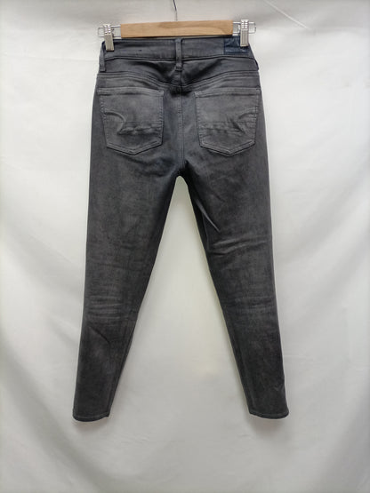 AMERICAN EAGLE. Jeans grises pitillo T.36