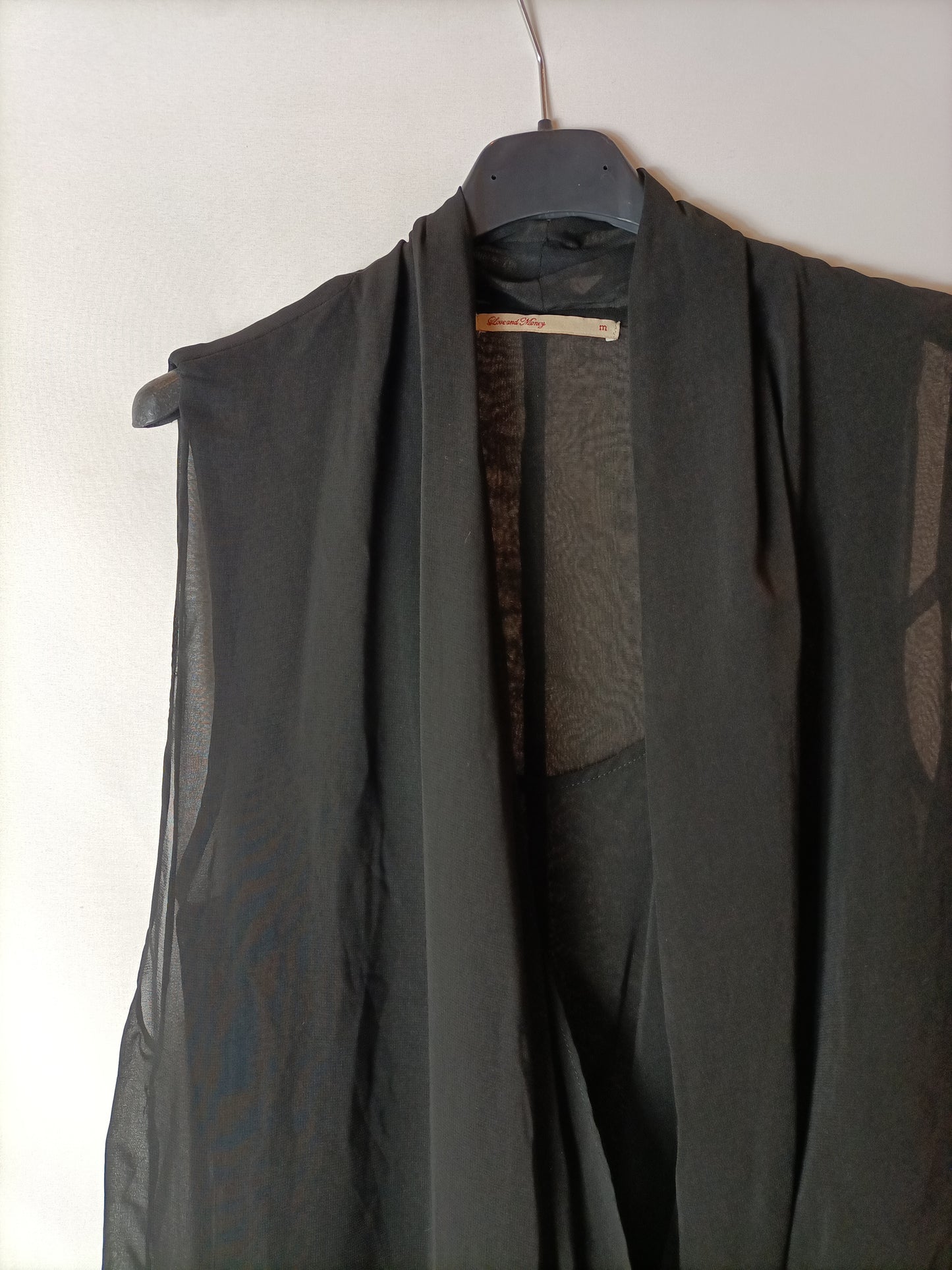 LOVE AND MONEY. Asymmetrical, semi-sheer black top. TM