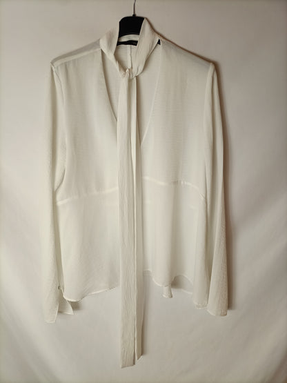 SFERA. White semi-sheer blouse with a bow at the neck. TM