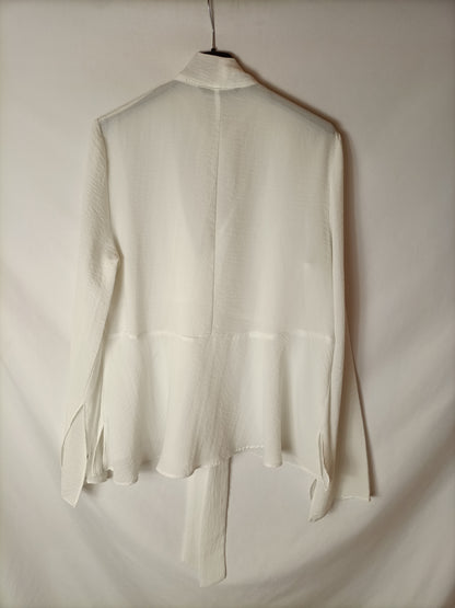 SFERA. White semi-sheer blouse with a bow at the neck. TM