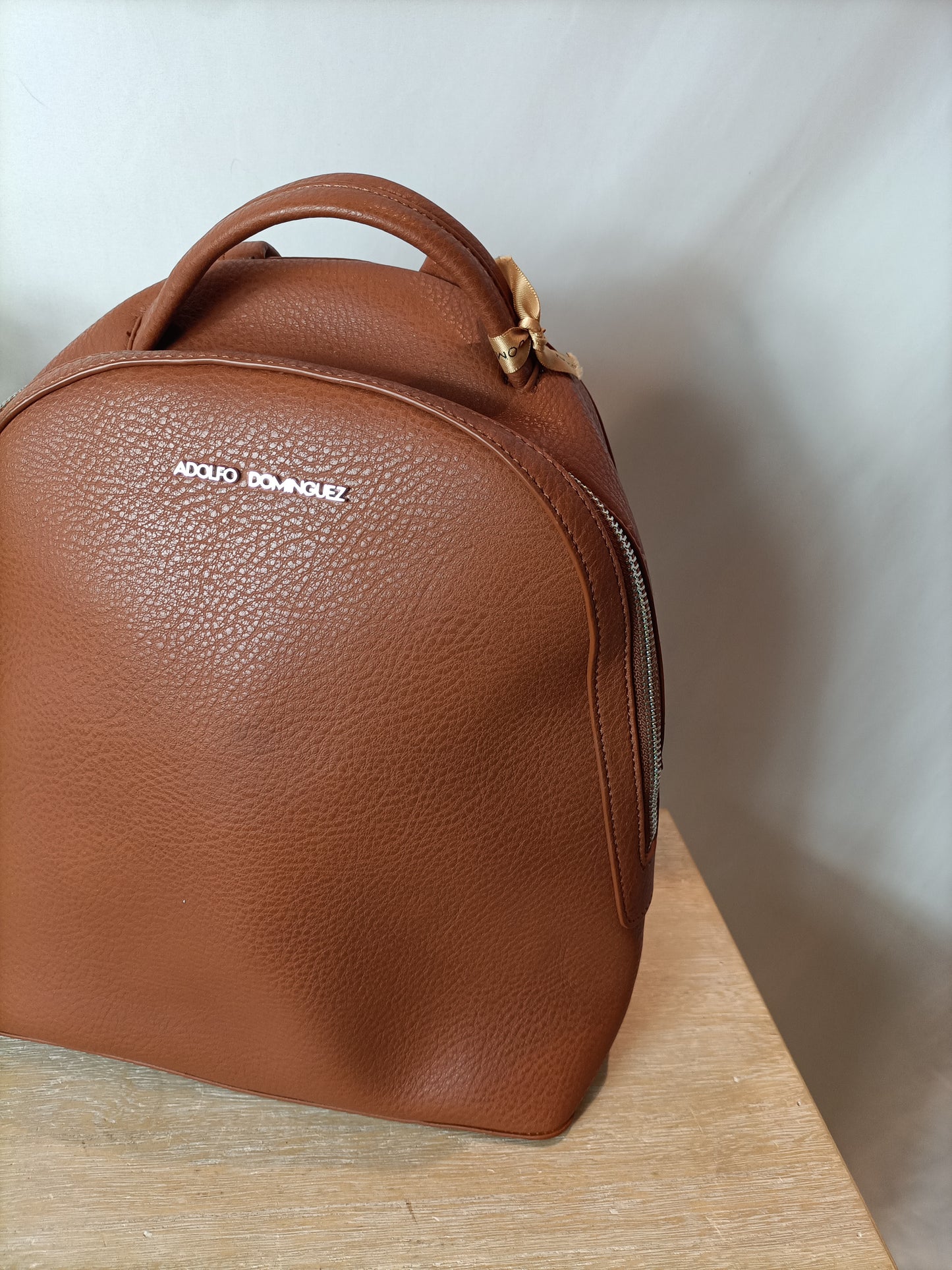 ADOLFO DOMINGUEZ. Brown leather backpack. (Tare)