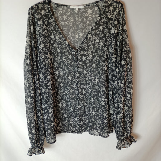 SCALPERS. Blusa negra calaveras. T S