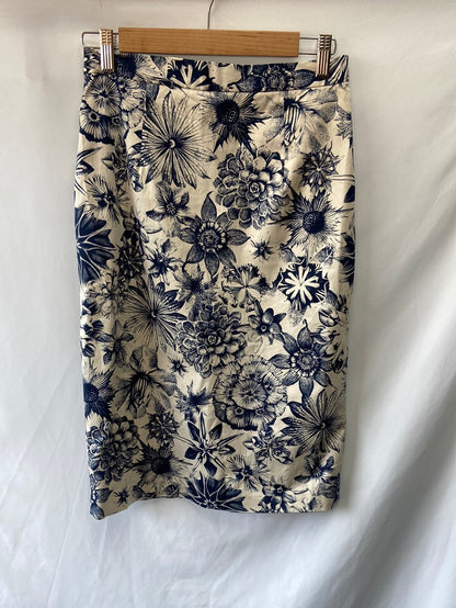 LYDIA DELGADO. Beige skirt with blue flowers.